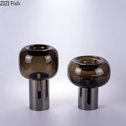Two sleek modern decorbites dark glass vases with amber hue and silver bases for office desk decor