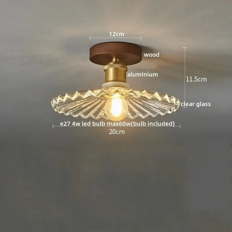 Vintage-style led ceiling lamp with dark wood base, brass aluminum stem, and clear scalloped glass shade for dining room