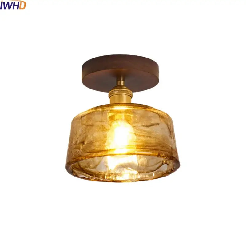 Modern amber glass and brass led ceiling lamp with dark wood mount ideal for dining room lighting