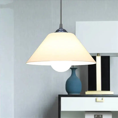 Modern cream-colored conical pendant light with iron finish and black fixture ideal for dining room lighting