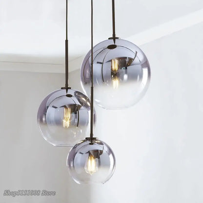 Modern amber glass ball led pendant light with metallic finish and exposed filament bulbs for kitchen decorbites decor