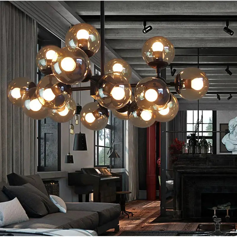 A modern amber glass ball pendant light with multiple glass globes on a dark metal frame for dining room decorbites chandelier