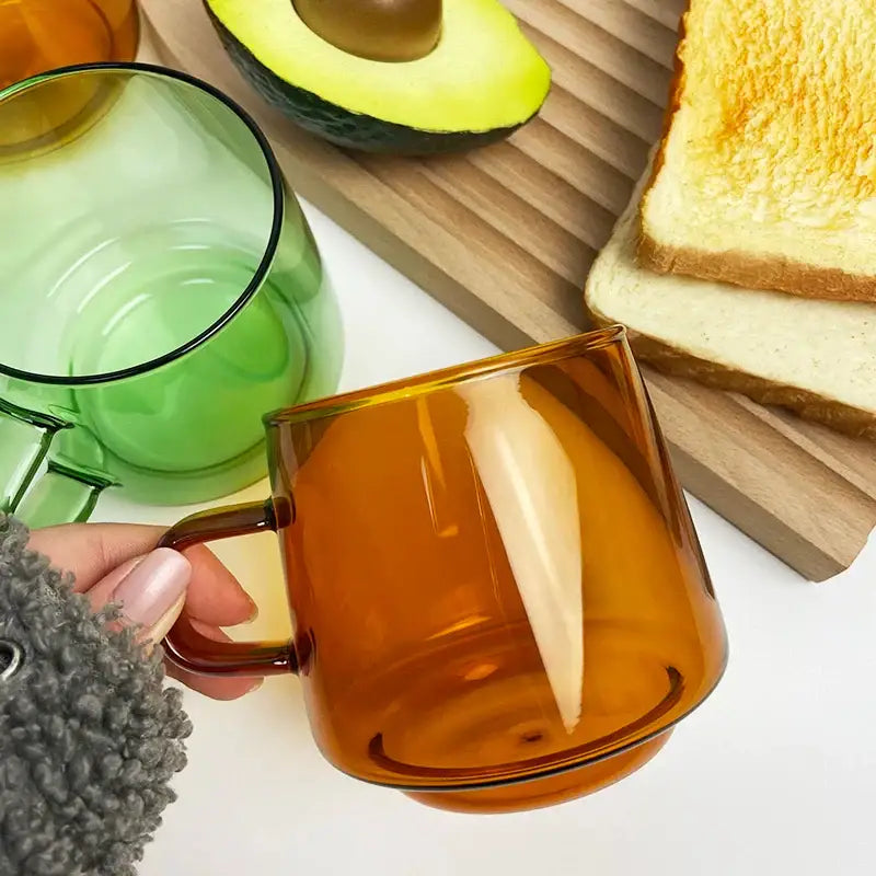 Modern amber glass coffee mug with black rim from decorbites glass coffee collection for kitchen and dining room decor