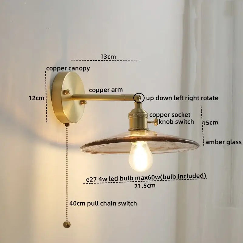 Antique brass-finished wall lamp with warm amber glass copper led shade and exposed edison-style bulb bedroom sconce