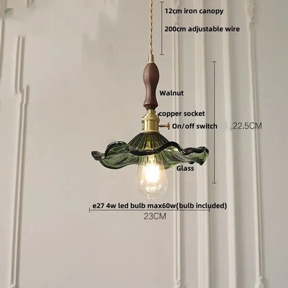 Delicate green glass led pendant lamp with walnut wood handle and brass accents for modern dining room lighting