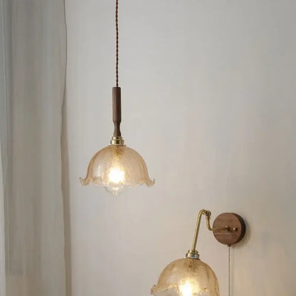 Modern amber glass led pendant lamp with warm-toned hand-blown fluted design and walnut wood accent cord