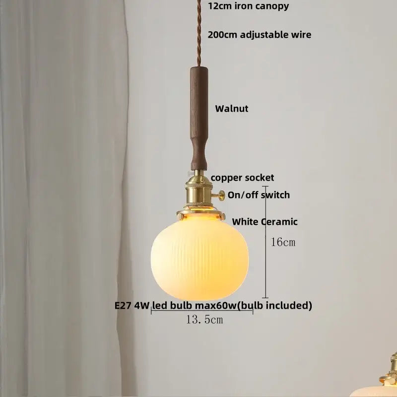 Modern amber glass led pendant light with warm white ceramic, ribbed glass globe, brass socket, and walnut wood canopy