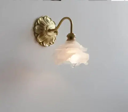 Antique brass led wall lamp with a delicate translucent pink glass shade for modern bedroom lighting