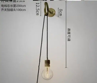 Modern amber glass led wall lamp featuring a vintage brass pendant light with a clear glass bulb and black cord