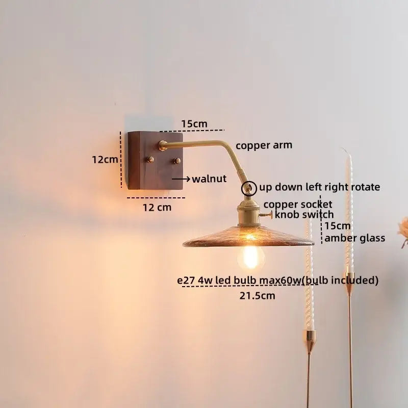 A warm-toned copper led wall sconce with a walnut mounting plate and amber glass shade for modern decorbites lighting