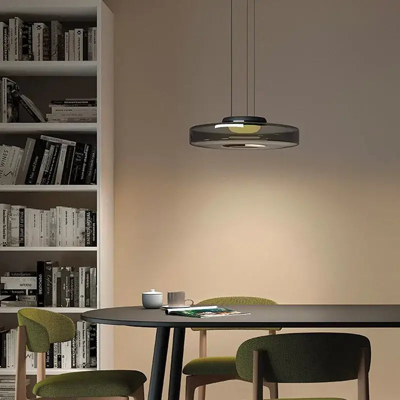 Modern amber glass plate ceiling pendant light with translucent dark gray glass and warm yellow led glow for dining room