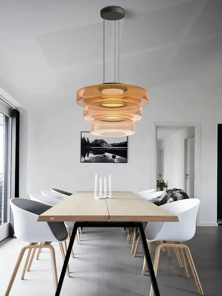 Modern amber glass plate ceiling pendant light with warm amber glass rings and a sleek metallic base for dining room