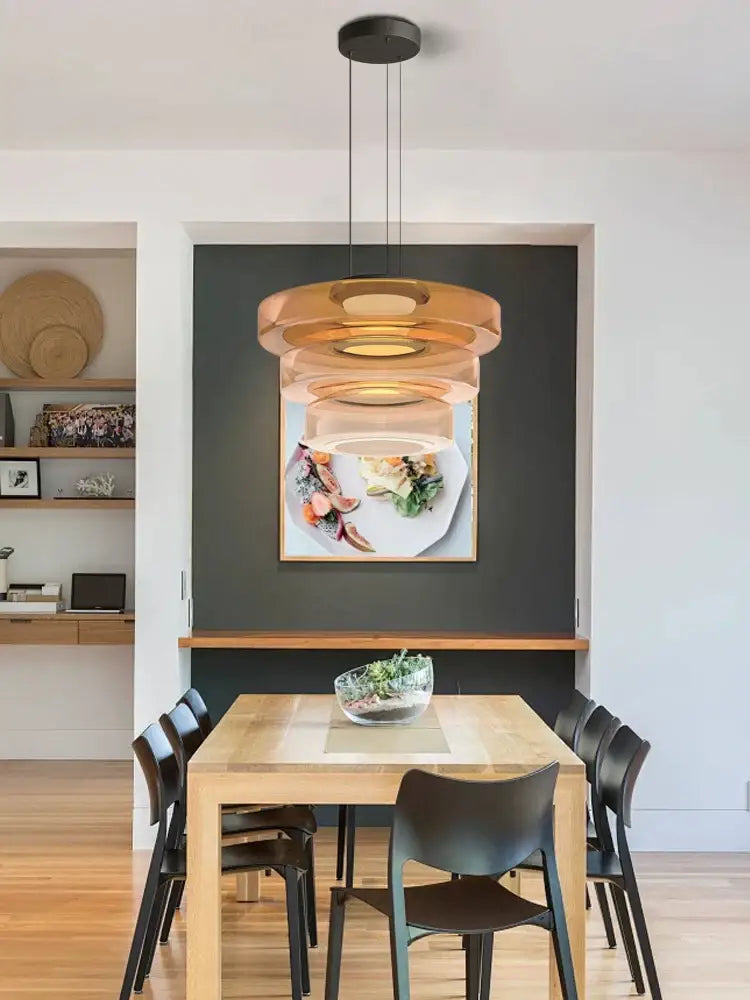 Modern amber glass plate ceiling pendant light with amber-toned concentric rings suspended by black cords