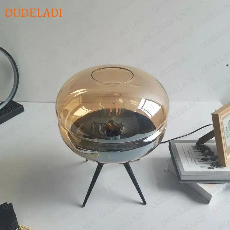 Modern amber glass table lamp with metallic black tripod base for bedroom decor by decorbites glass table lamp