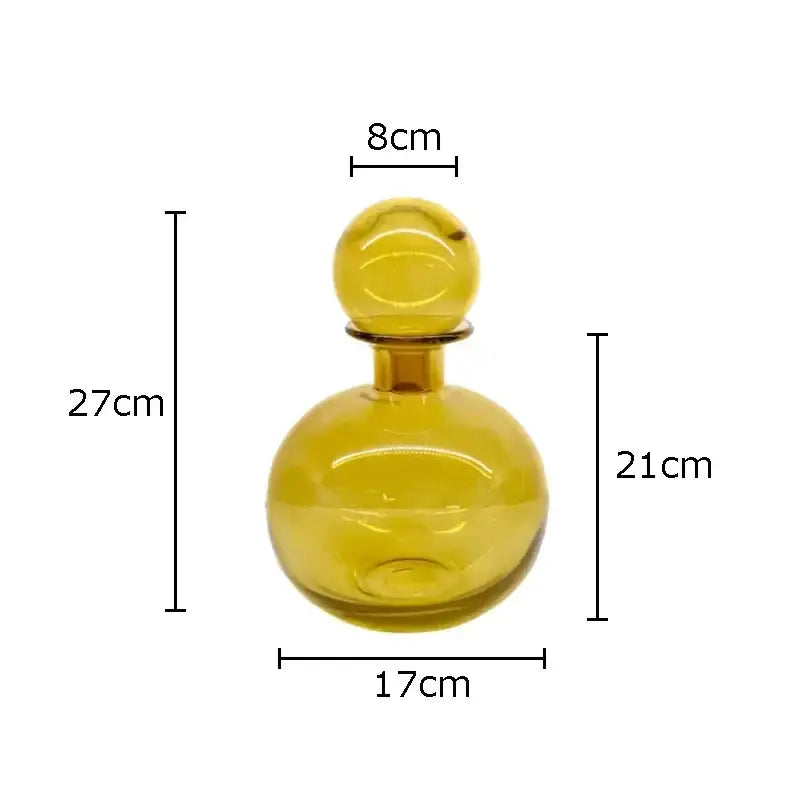 A modern decorbites amber glass vase featuring a translucent rounded decanter with a slender neck and spherical stopper
