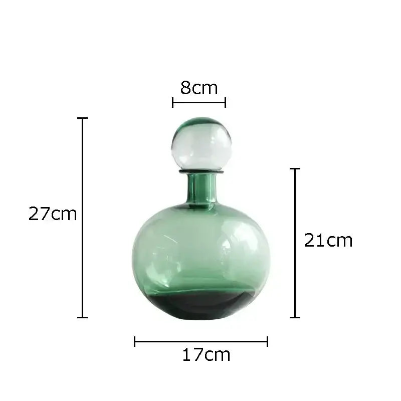 A translucent green glass decanter with a spherical stopper from decorbites amber glass vase trio for hydroponic decor