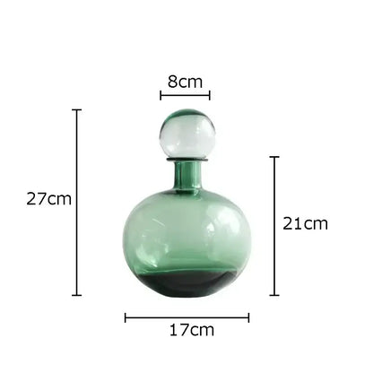 A translucent green glass decanter with a spherical stopper from decorbites amber glass vase trio for hydroponic decor