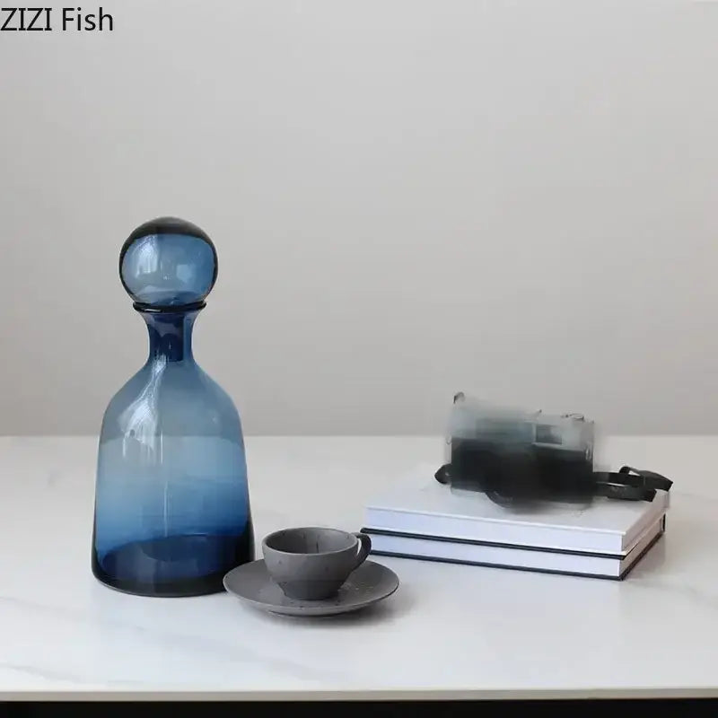 A sleek gradient blue glass decanter with rounded stopper for modern amber glass vase trio decorbites amber glass decor