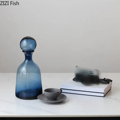 A sleek gradient blue glass decanter with rounded stopper for modern amber glass vase trio decorbites amber glass decor