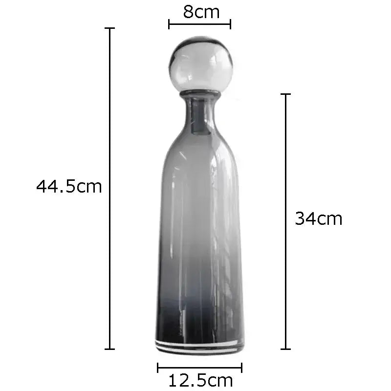 A sleek decorbites amber glass vase trio featuring gradient glass decanters with spherical stoppers for modern decor