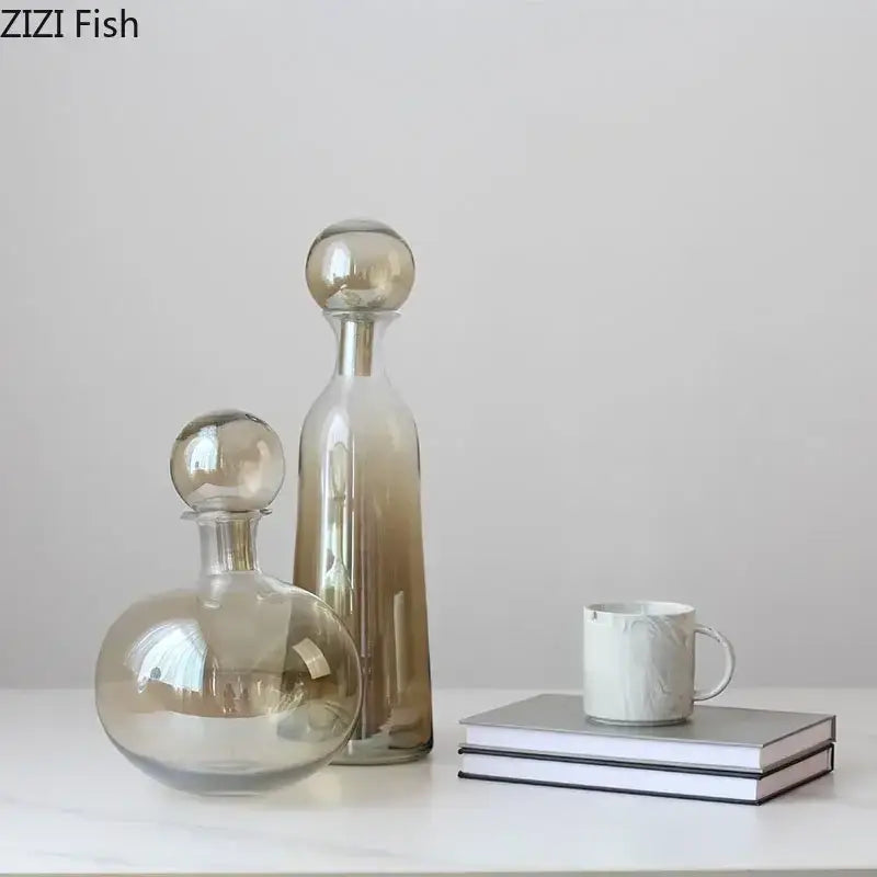 Two elegant decorbites amber glass decanters with spherical stoppers featuring clear to amber gradient hues
