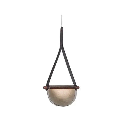A sleek half-moon pendant lamp with matte gold metal and dark brown leather straps by decorbites handmade leather