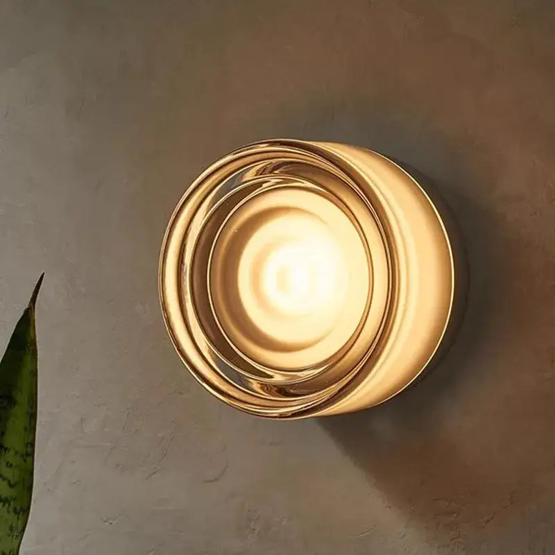 Modern amber jelly led wall sconce with concentric gold-toned glass rings providing warm bedroom lighting decorbites amber jelly
