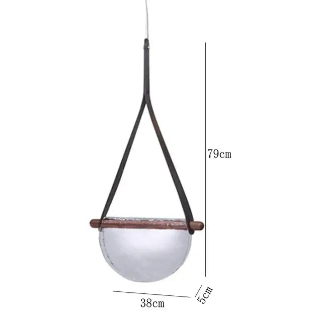 Minimalist pendant lamp with amber handmade glass bowl, dark wood rim, and black leather straps for bedroom decorbites handmade glass