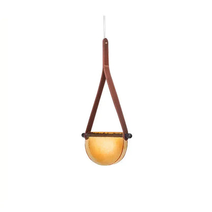 A modern amber pendant lamp with a warm glass bowl suspended by leather straps decorbites handmade glass pendant