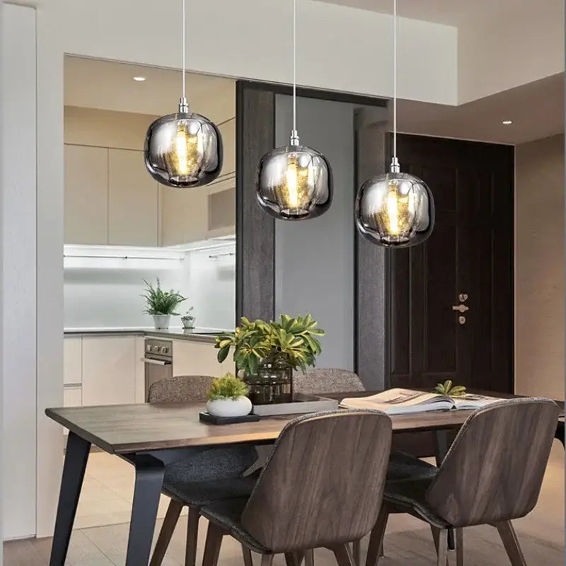 Modern amber and smoke crystal staircase chandelier with three spherical glass pendant lights and metallic sheen