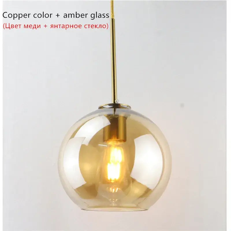 Copper-toned pendant lights with spherical amber glass ball led shade perfect for modern dining room decorbites glass ball