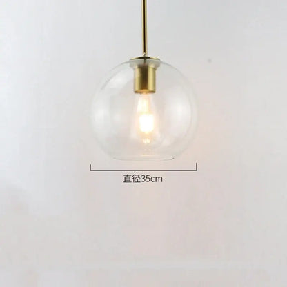Modern amber smoked gray and clear glass ball led pendant lights with a clear globe and brass decorbites glass ball fixture