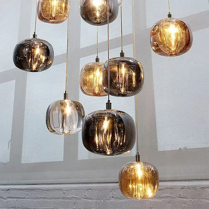 Modern amber and smoky grey crystal staircase chandelier with spherical glass pendant lights for dining room