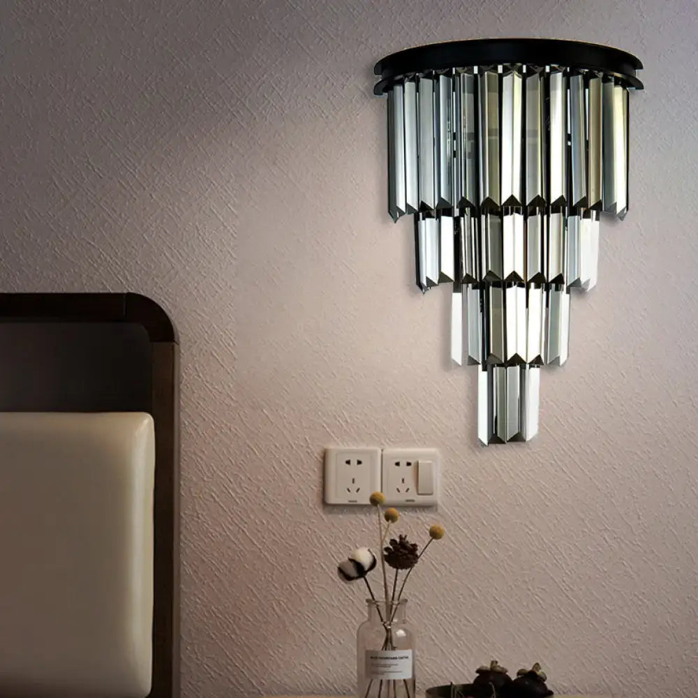 Modern amber clear amber tiered crystal wall mounted fixture with black base and cascading glass panels for living room