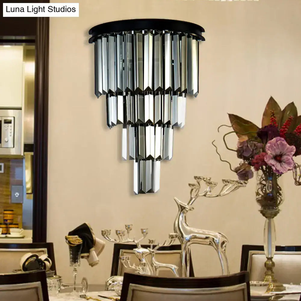 Black-framed wall mounted fixture with cascading clear amber faceted crystal prisms and adjustable fixture height