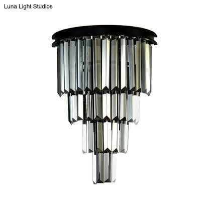 Modern amber tiered wall mounted lamp with clear amber faceted glass prisms and black finish fixture height detail