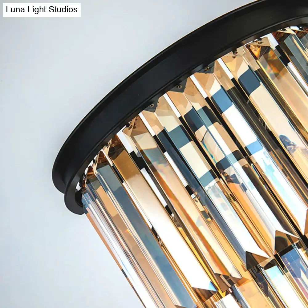 Modern amber tiered wall mounted lamp with clear amber crystal prisms and sleek black frame fixture height shown