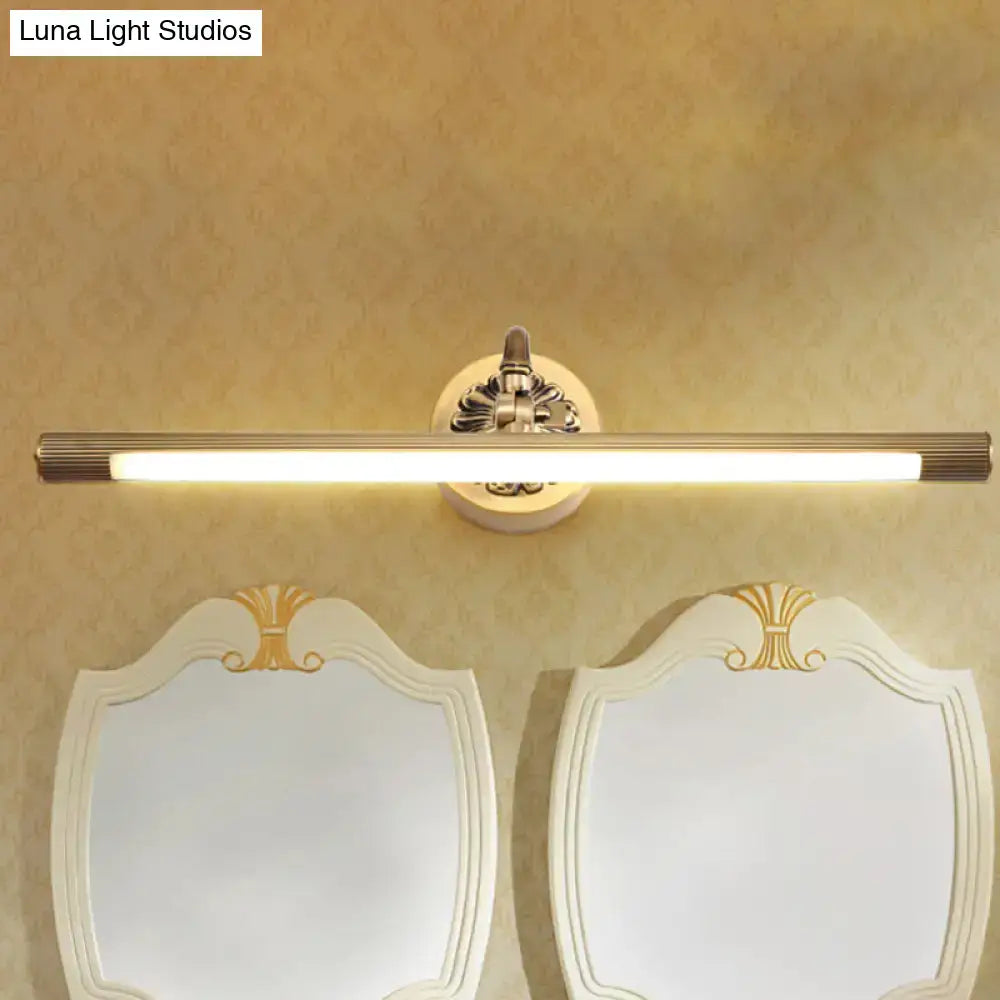 Modern antique brass integrated led wall light with gold-finished bar and ornate decorative mounting plate for vanity