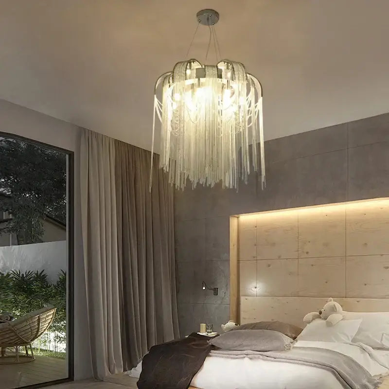 Modern arched gold aluminum chain chandelier with translucent glass cascading fringed strands for living room light