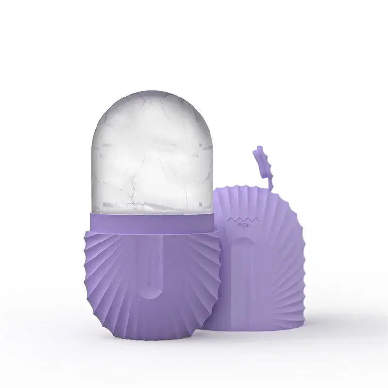 Purple silicone clamshell-shaped ice cube tray with clear marble-patterned dome for modern arched pink marble facial roller massager