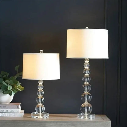 Modern art deco crystal ball table lamp with clear glass stacked spherical base and cream drum shade for bedroom decor