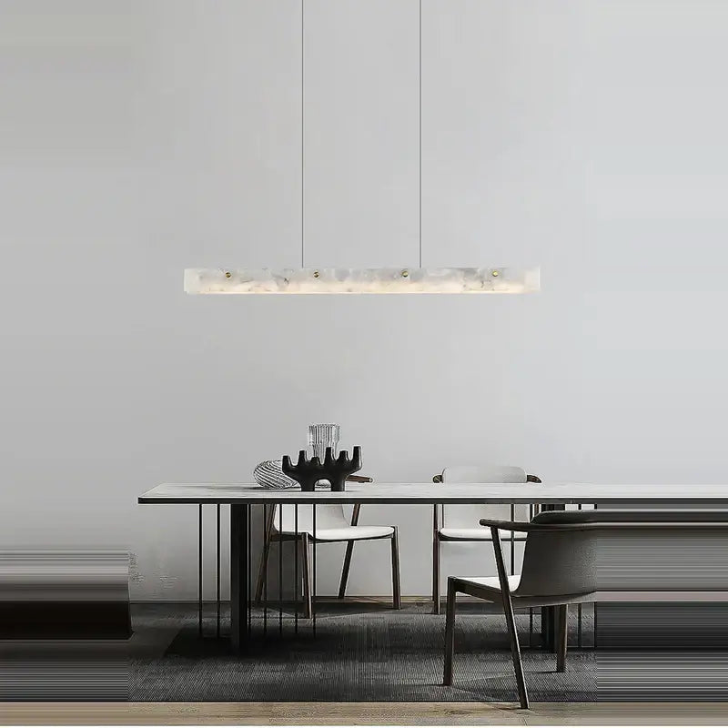 A sleek rectangular pendant light with art deco marble finish and embedded led lighting for dining room decorbites art deco