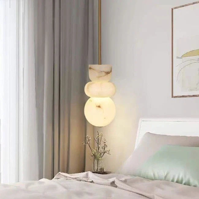 Modern pendant light with three glowing alabaster indoor ceiling spherical shades made of spanish marble for kitchen decor