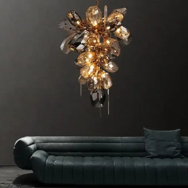 Modern artistic gold crystal duplex chandelier with faceted amber and clear glass crystals above dark teal sofa for living room decorbites crystal duplex