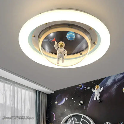 Circular ceiling lamp with a white astronaut spaceman figurine inside frosted glass rings for kids bedroom light