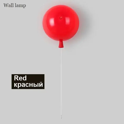 Red balloon wall light with a glossy finish and thin white cord for modern bedroom wall lighting