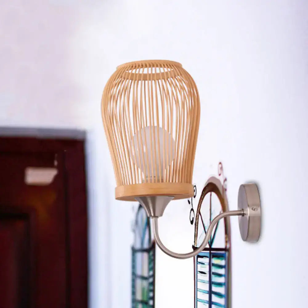 Beige bamboo cage wall sconce with metal gooseneck arm and circular mounting plate for modern bedroom lighting