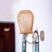 Beige bamboo cage wall sconce with metal gooseneck arm and circular mounting plate for modern bedroom lighting