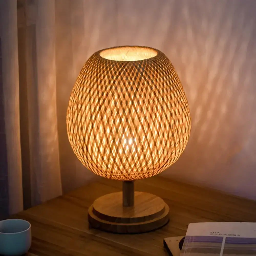 Warm-toned modern bamboo weave table lamp with circular wooden base for bedroom use