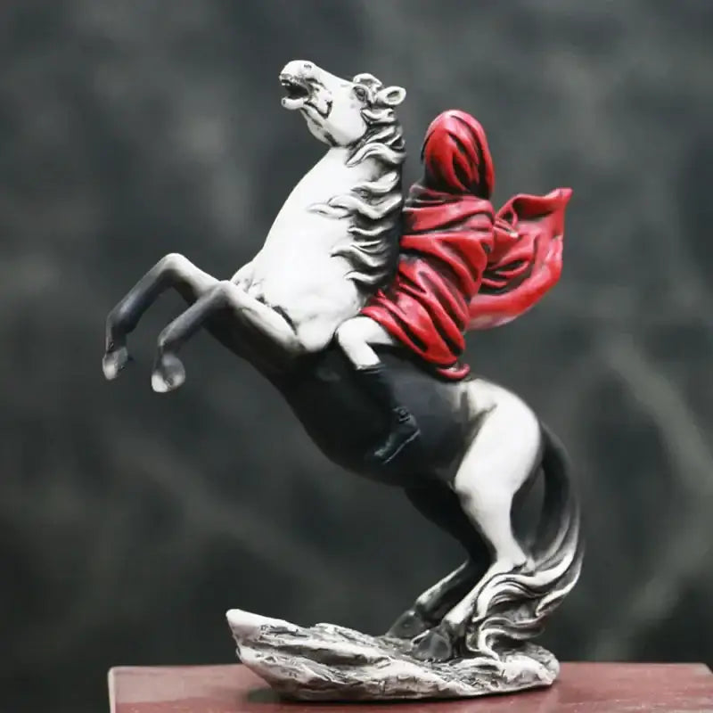 A modern black and white resin red knight statue with a rider in a flowing red cloak for living room decor